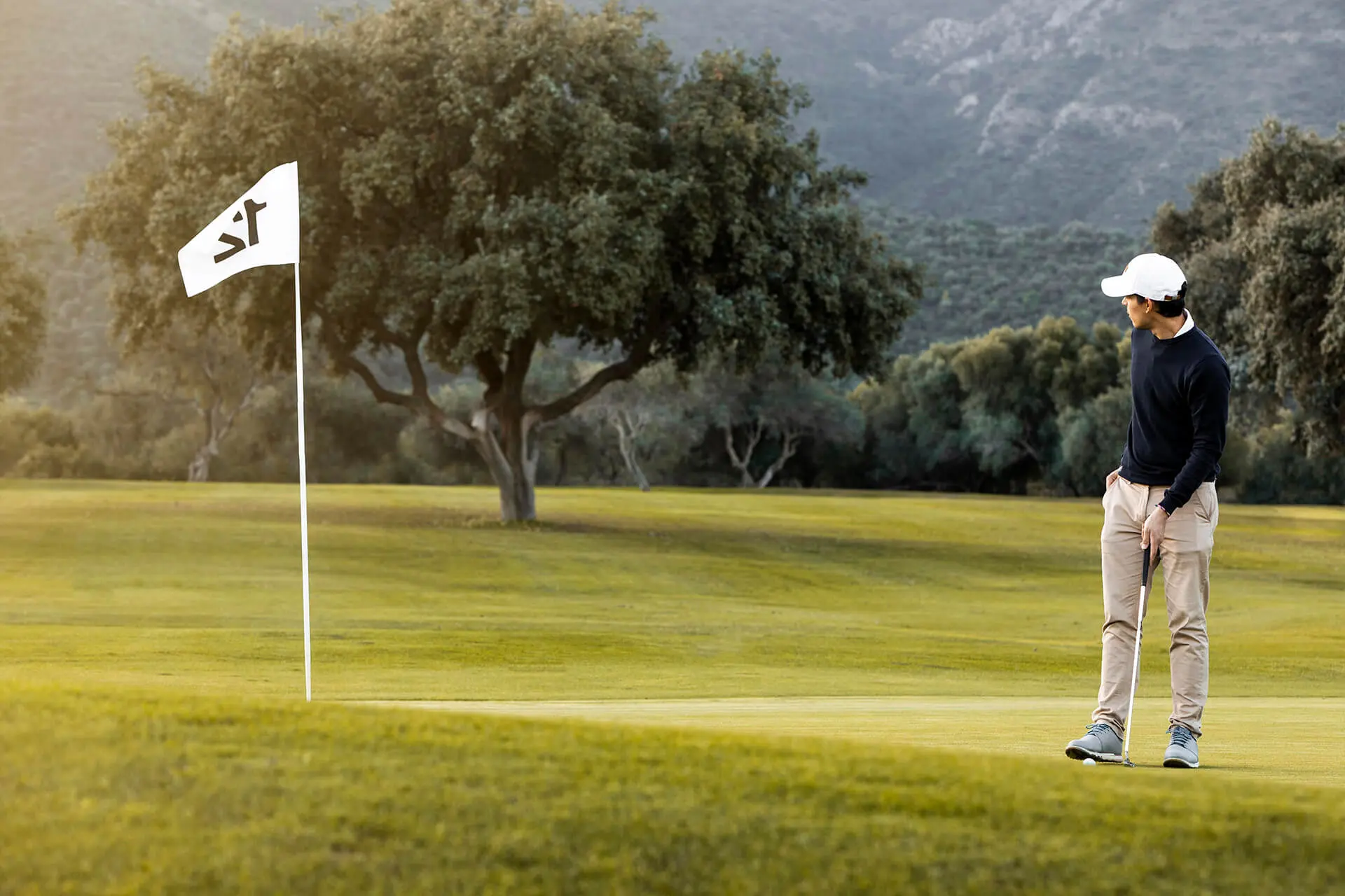 man-golf-field-flag Man on the golf field next to a flag